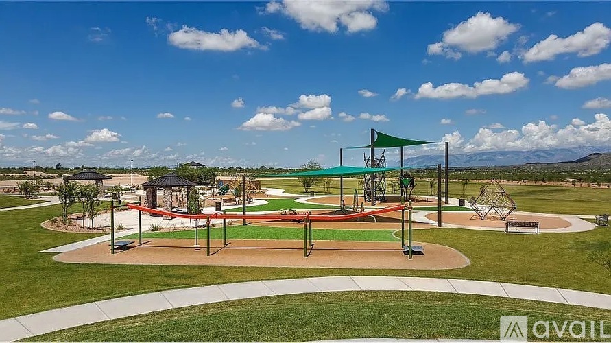 A park with a playground and a baseball field.