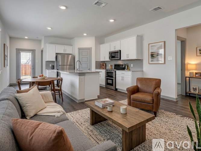 A modern kitchen with white cabinets and stainless steel appliances.