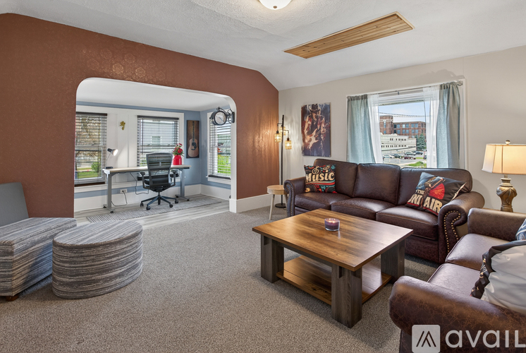 A living room with a brown couch and a wooden coffee table.
