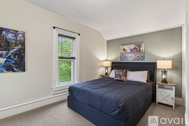 A bedroom with a large bed and a window.