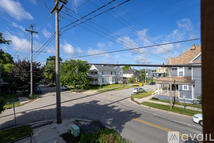 A street view with houses and cars on a sunny day.