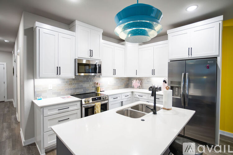 A modern kitchen with white cabinets and a large island.