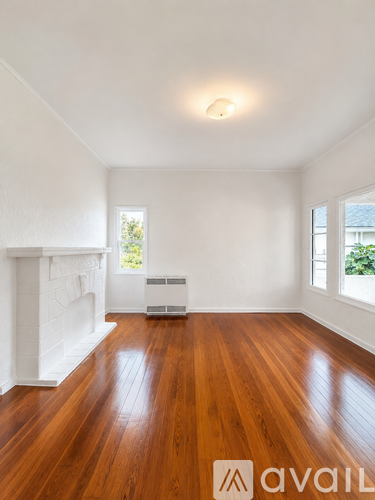 A room with wooden floors and white walls.