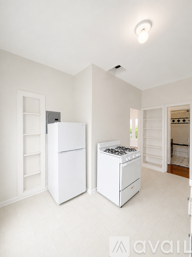 A kitchen with a white fridge and stove.