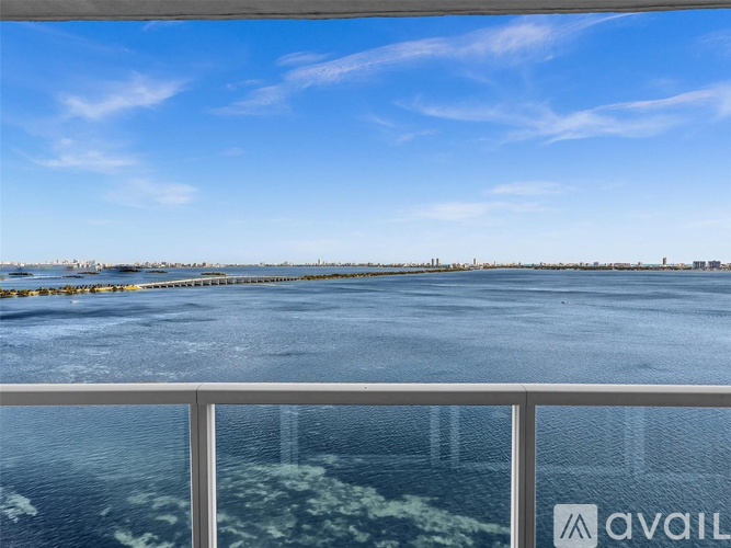 A view from a balcony overlooking a frozen body of water with a city skyline in the distance.