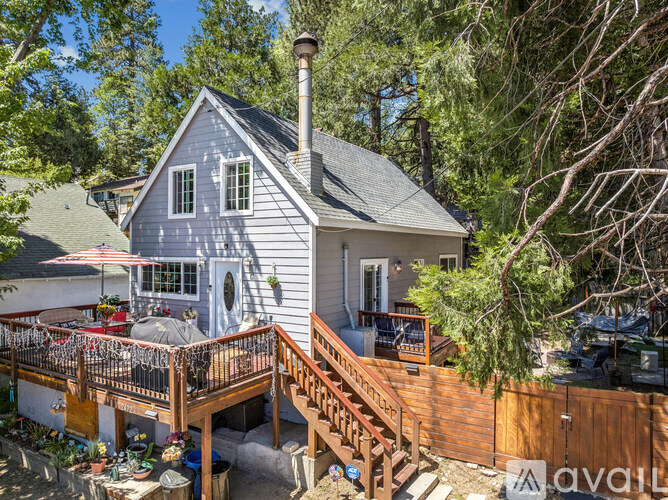 A house with a grey exterior and a wooden deck.
