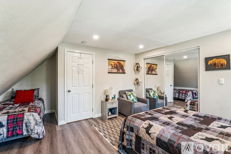 A bedroom with two beds and a couch.