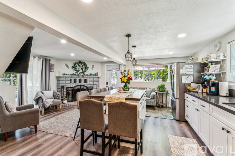 A modern kitchen with a dining table set for two.