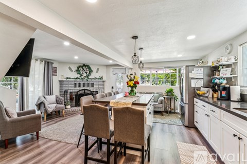 A modern kitchen with a dining table set for two.