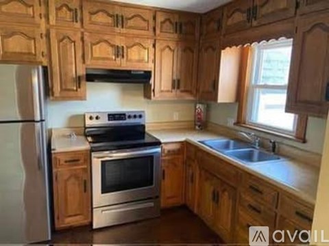A kitchen with wooden cabinets and stainless steel appliances.
