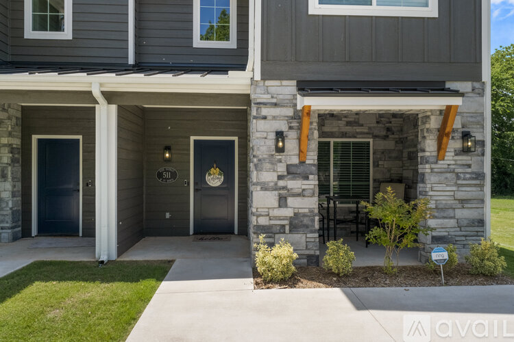 A modern house with a stone facade and a garage door.