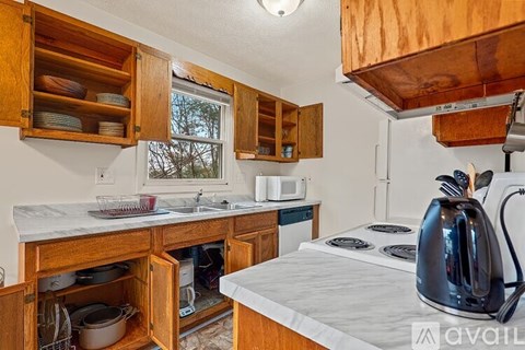 A kitchen with wooden cabinets and a white countertop.