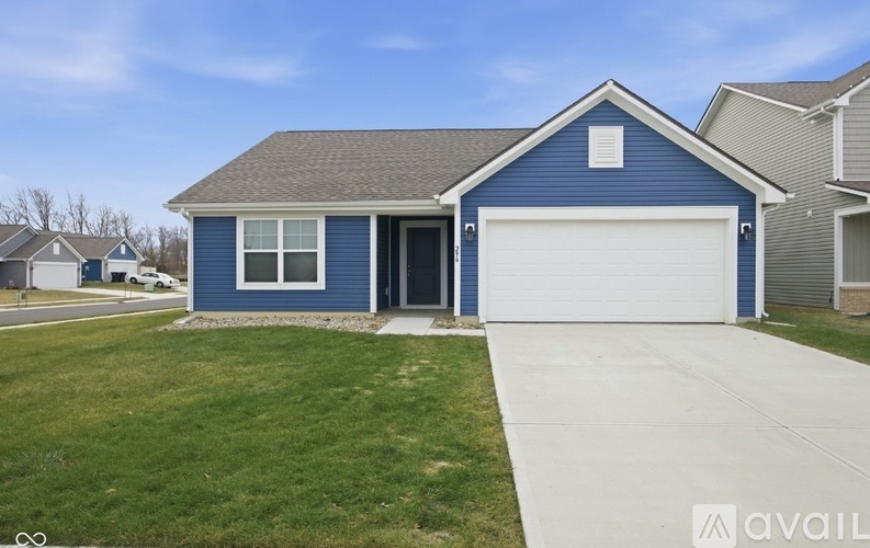 A blue house with a white garage door is for sale.