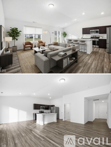 A modern living room with a kitchen in the background.