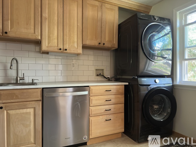 A kitchen with wooden cabinets and a dishwasher.
