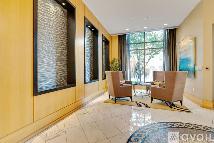 A spacious room with a long table and chairs.