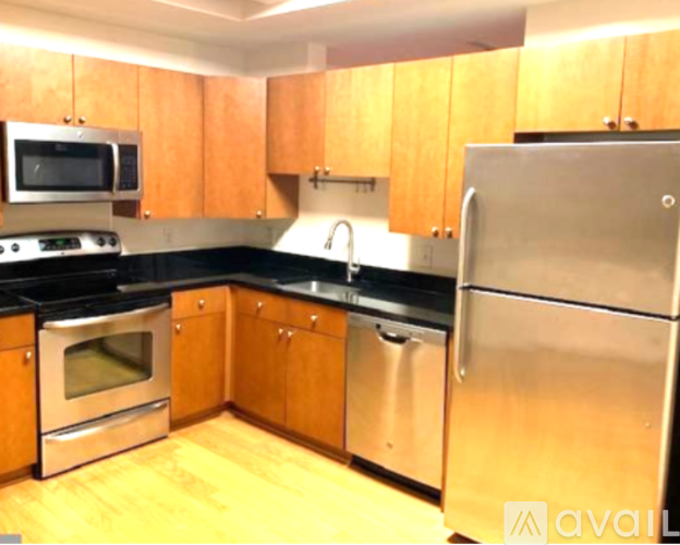 A kitchen with wooden cabinets and stainless steel appliances.