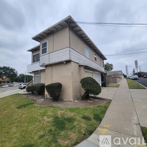 A two-story house with a balcony on the second floor.