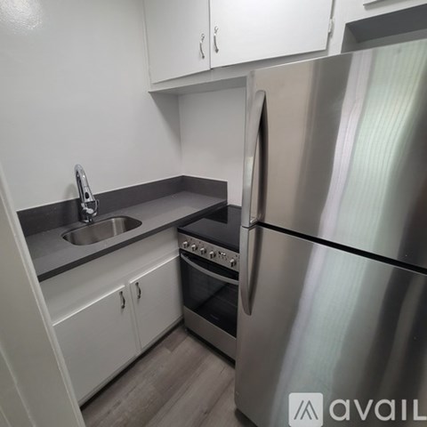 A modern kitchen with a stainless steel refrigerator and oven.