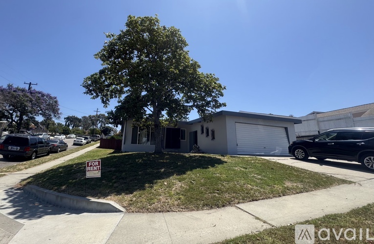 A house with a "For Sale" sign in front of it.