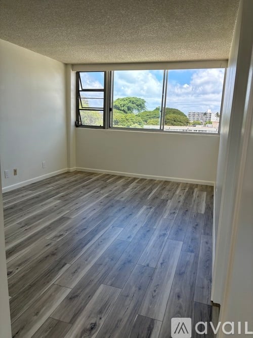 A room with a window overlooking a cityscape.