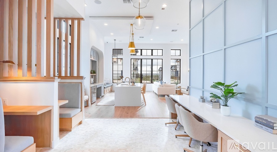A modern office space with a long white table and chairs.