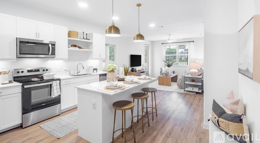 A modern kitchen with white cabinets and a wooden island.