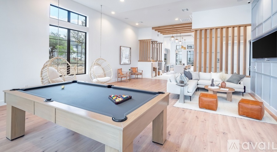 A pool table is in the middle of a living room.