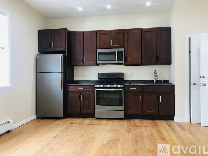A kitchen with wooden cabinets and stainless steel appliances.