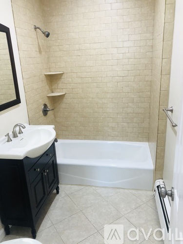A bathroom with a white sink and a white tub.