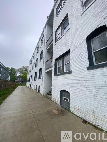 A white building with a grey door and windows.