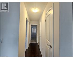 A long hallway with a door on the right.