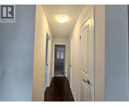 A long hallway with a door on the right.