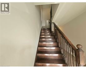 A wooden staircase with a railing on the side.