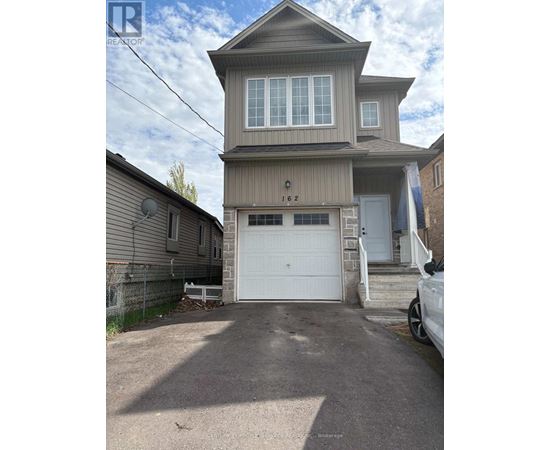A two-story house with a garage is for sale.