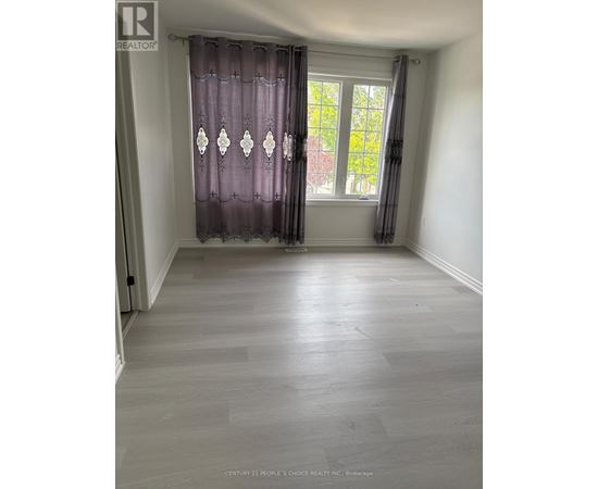 A room with a window and curtains.