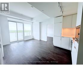 A spacious room with wooden floors and white walls.