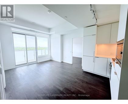 A spacious room with wooden floors and white walls.