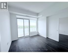 A spacious room with a view of the outside through the sliding glass door.