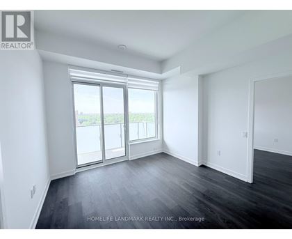 A spacious room with a view of the outside through the sliding glass door.