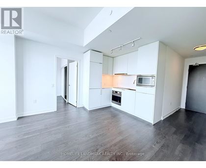 A spacious kitchen with white cabinets and a microwave above the oven.