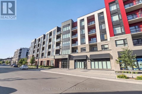 A street view of a multi-story building with the number 3265 on it.