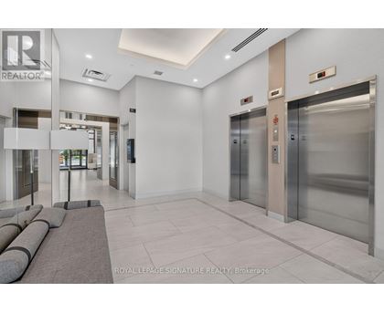 A hallway with a sign that says "REALTOR" on the wall.