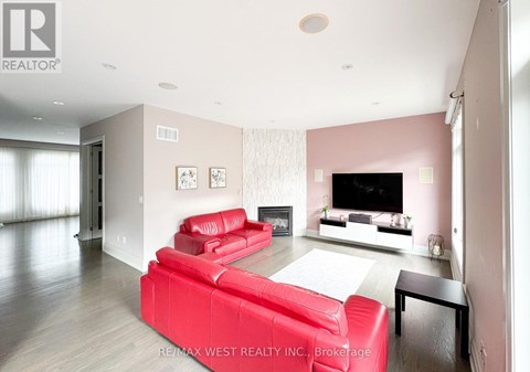 A living room with a red couch and a television.