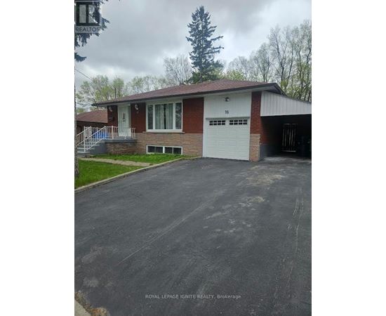 A residential house with a driveway in front.