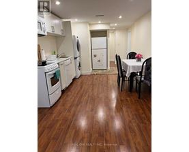A kitchen with a table and chairs in the middle of the room.
