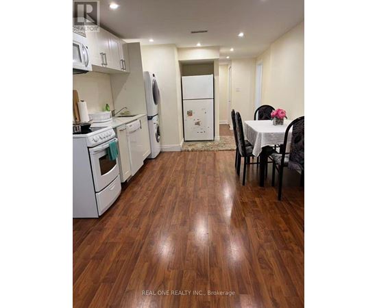 A kitchen with a table and chairs in the middle of the room.