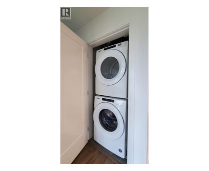 A white washing machine is in a small space.
