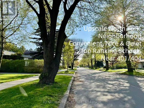 A residential street with the text overlay describing it as an upscale neighborhood with top-ranking schools.
