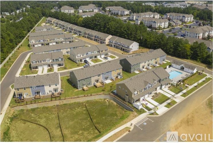 An aerial view of a housing complex with a swimming pool.